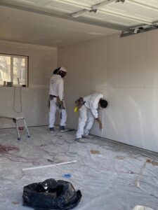 Putting up drywall in a garage