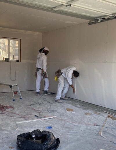 Putting up drywall in a garage