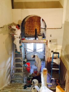 workmen plastering a school The Wall Rebuilders Colorado